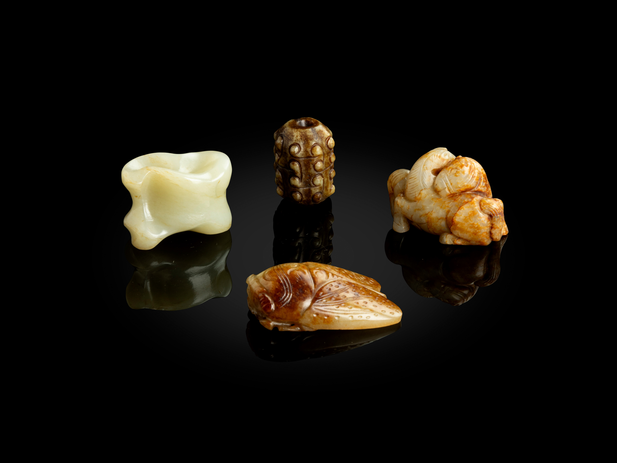 GROUP OF FOUR JADE PENDANTS