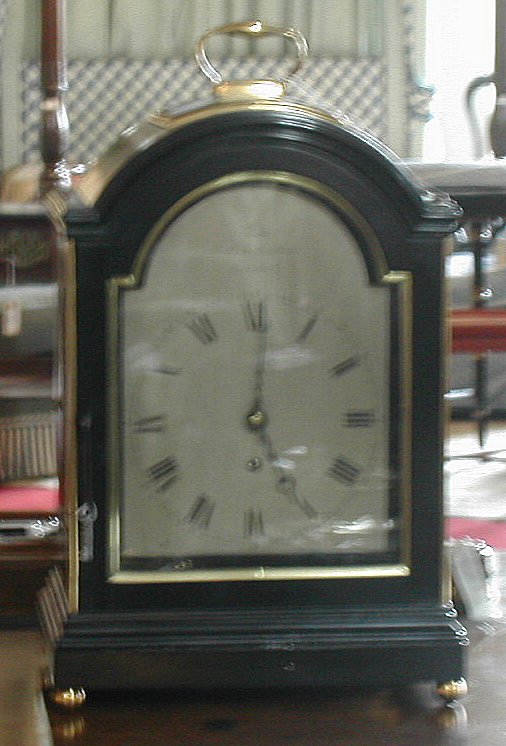 A George III ebonised and gilt brass mounted bracket timepiece