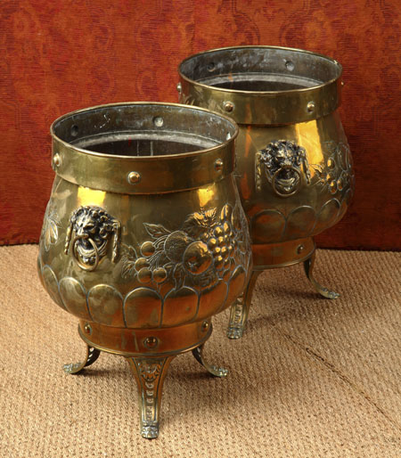 A pair of large embossed brass log bins