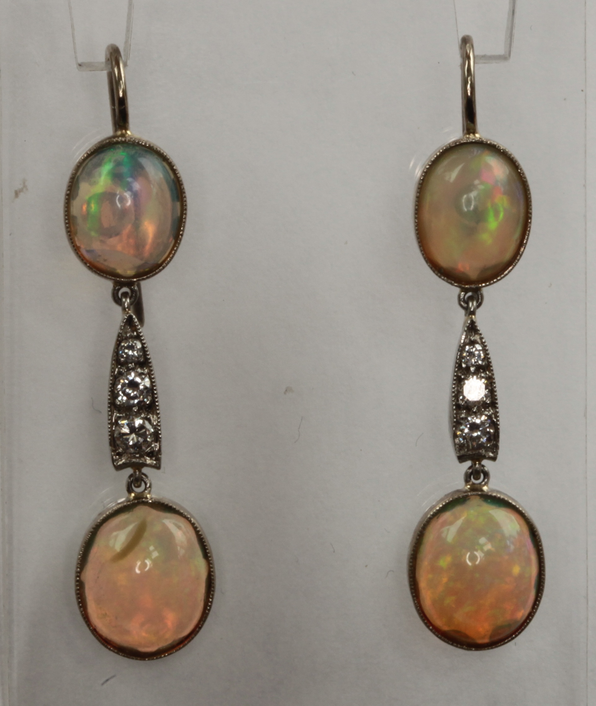 A pair of opal and diamond set ear pendants