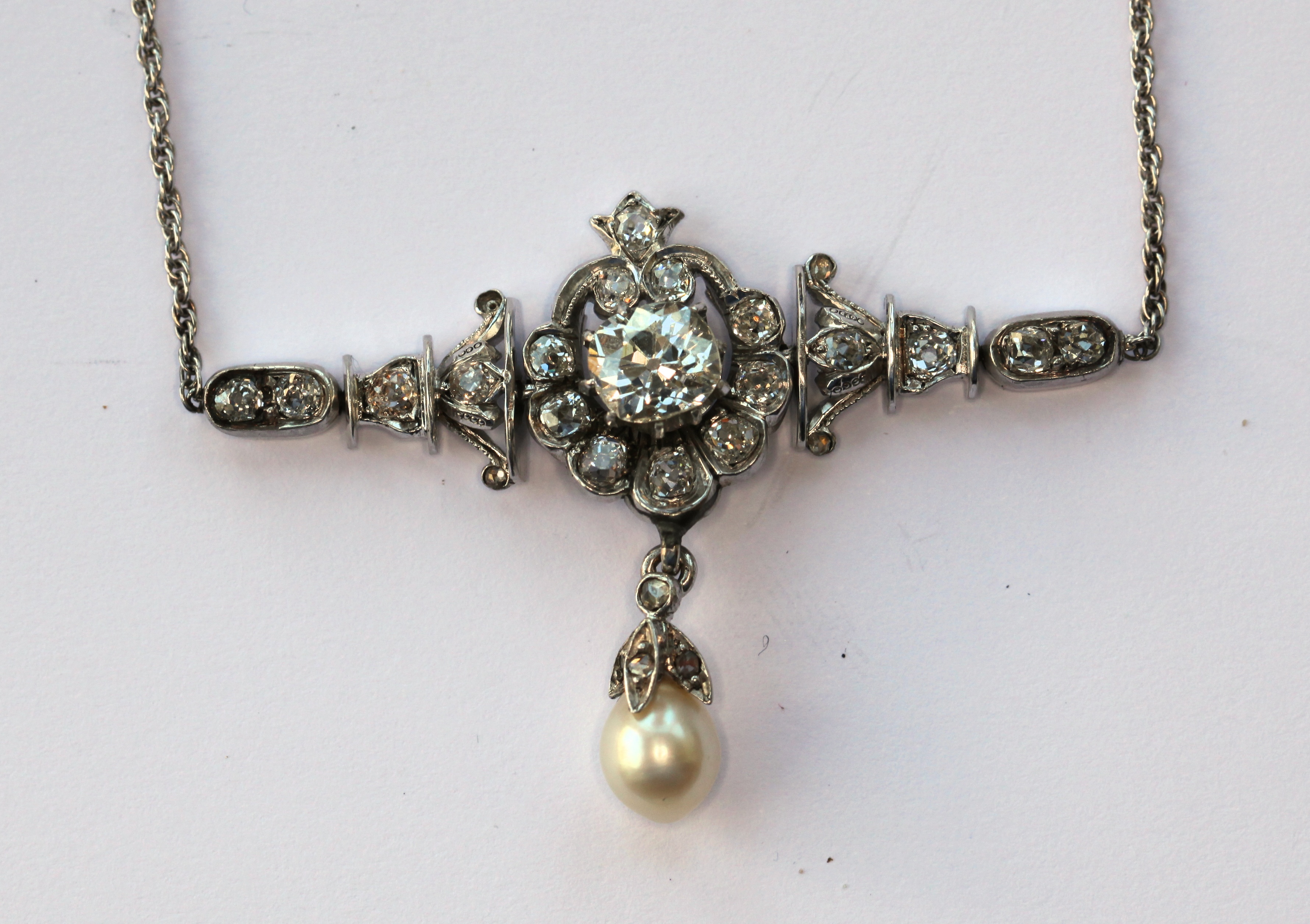 An early 20th century diamond and pearl set necklace