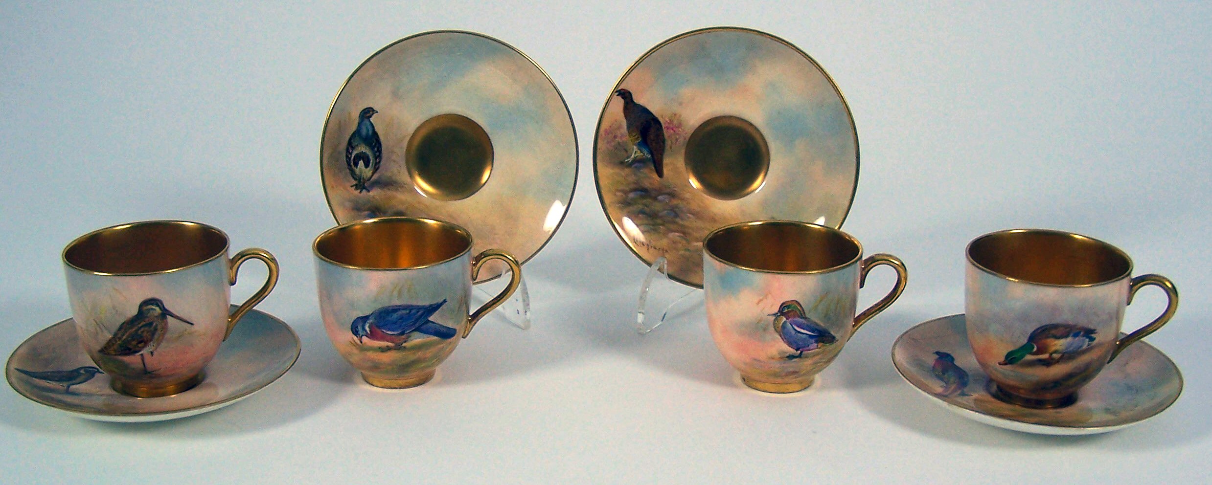 A set of four Royal Worcester coffee cups and saucers,