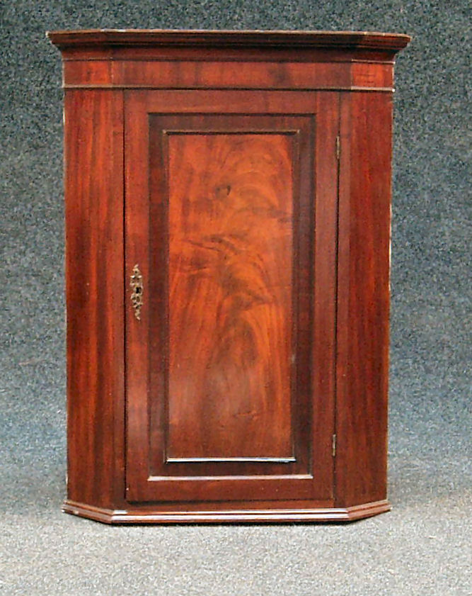 A George III mahogany corner cabinet,