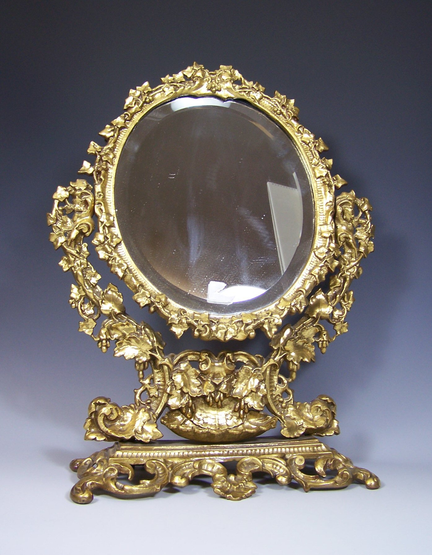 A gilt cast iron table mirror,