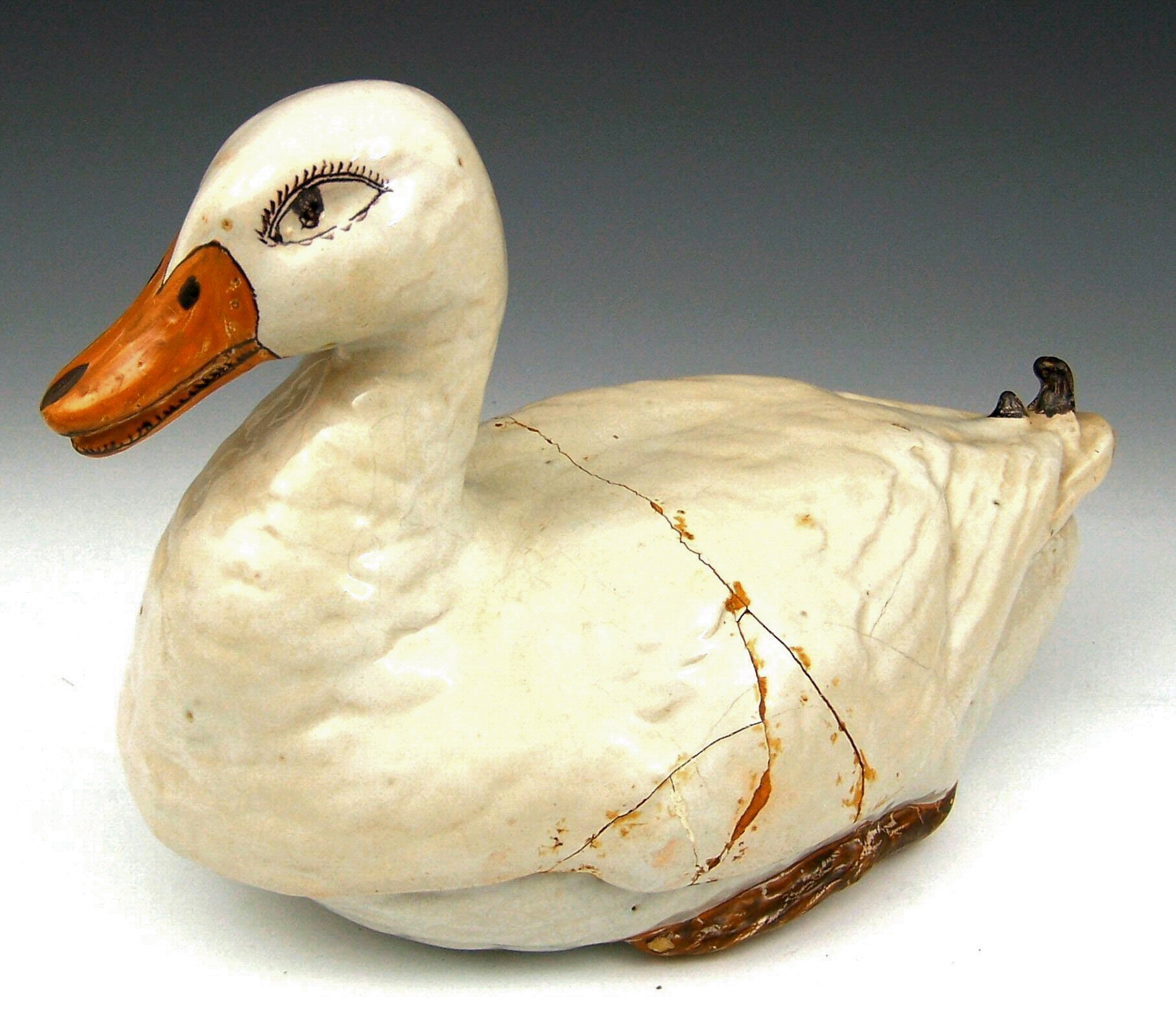 A 19th century French faience tureen and cover in the form of a duck,