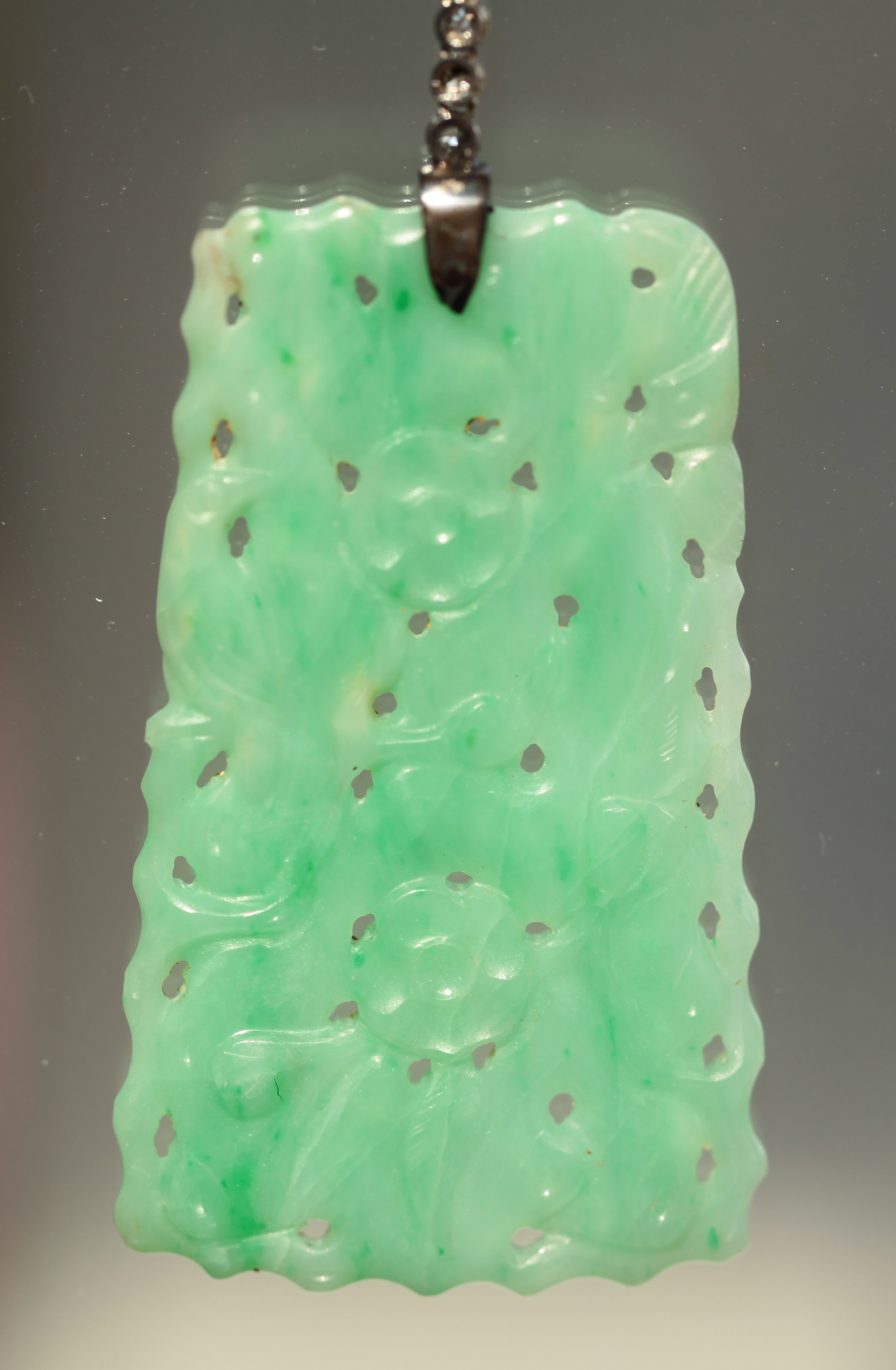 An early 20th century jade and diamond set pendant