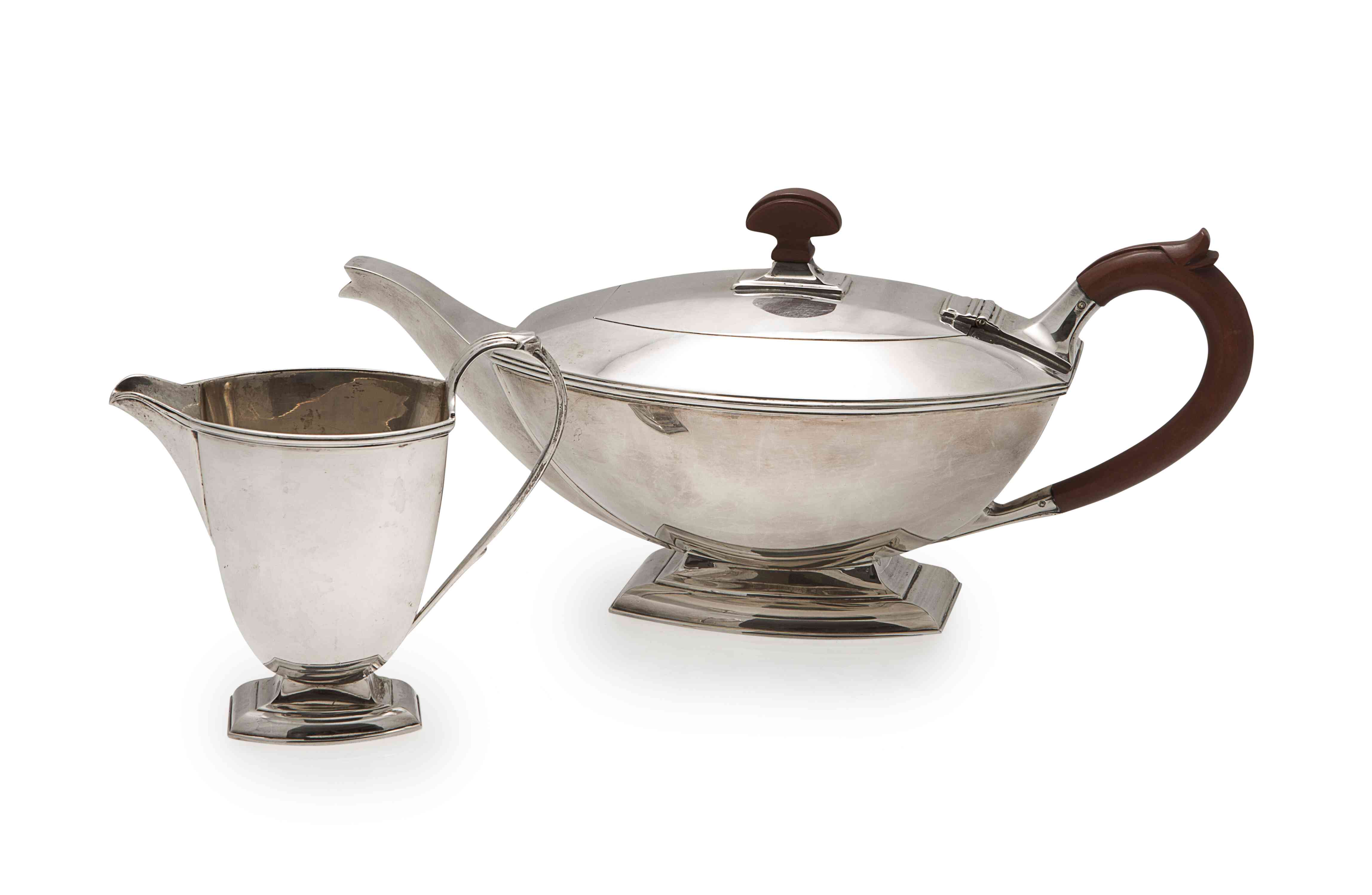 An Art Deco teapot and cream jug