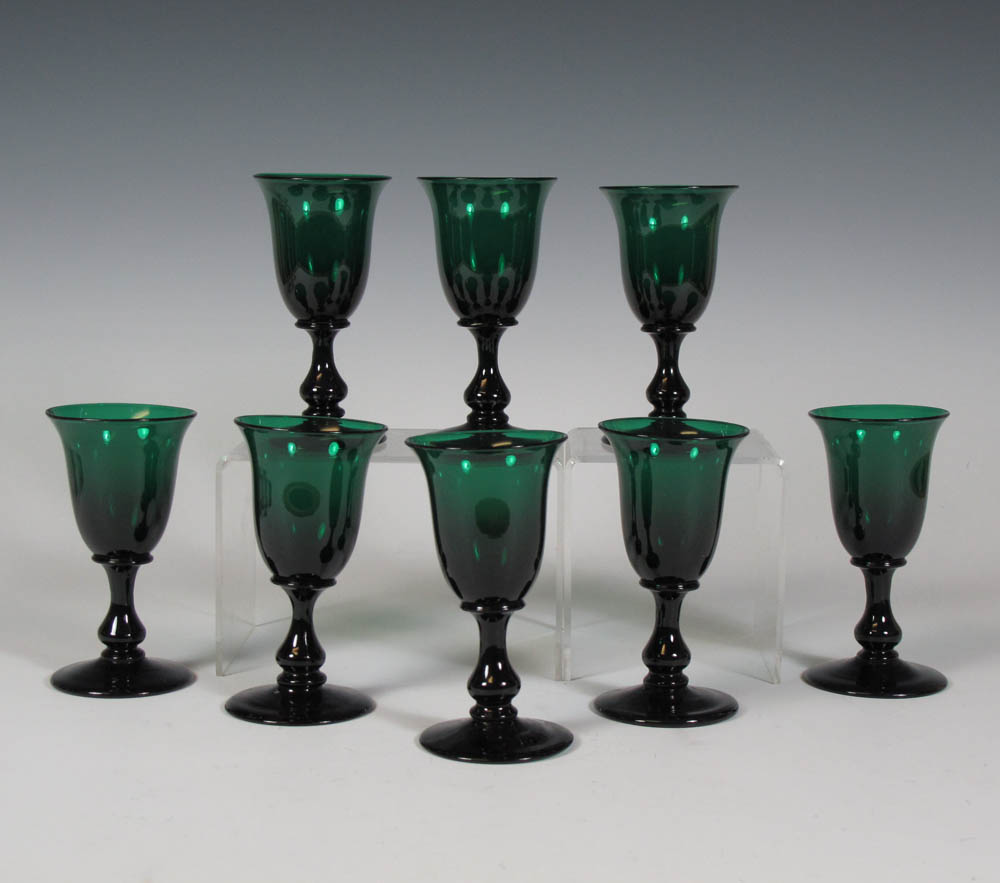 A group of eight green glasses