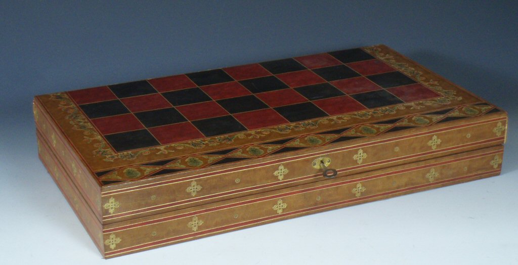 A red, black and brown tooled gilt leather chess/backgammon board Retailed by Fortnum & Mason