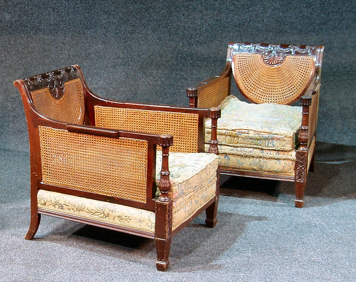 A pair of Edwardian mahogany bergere armchairs