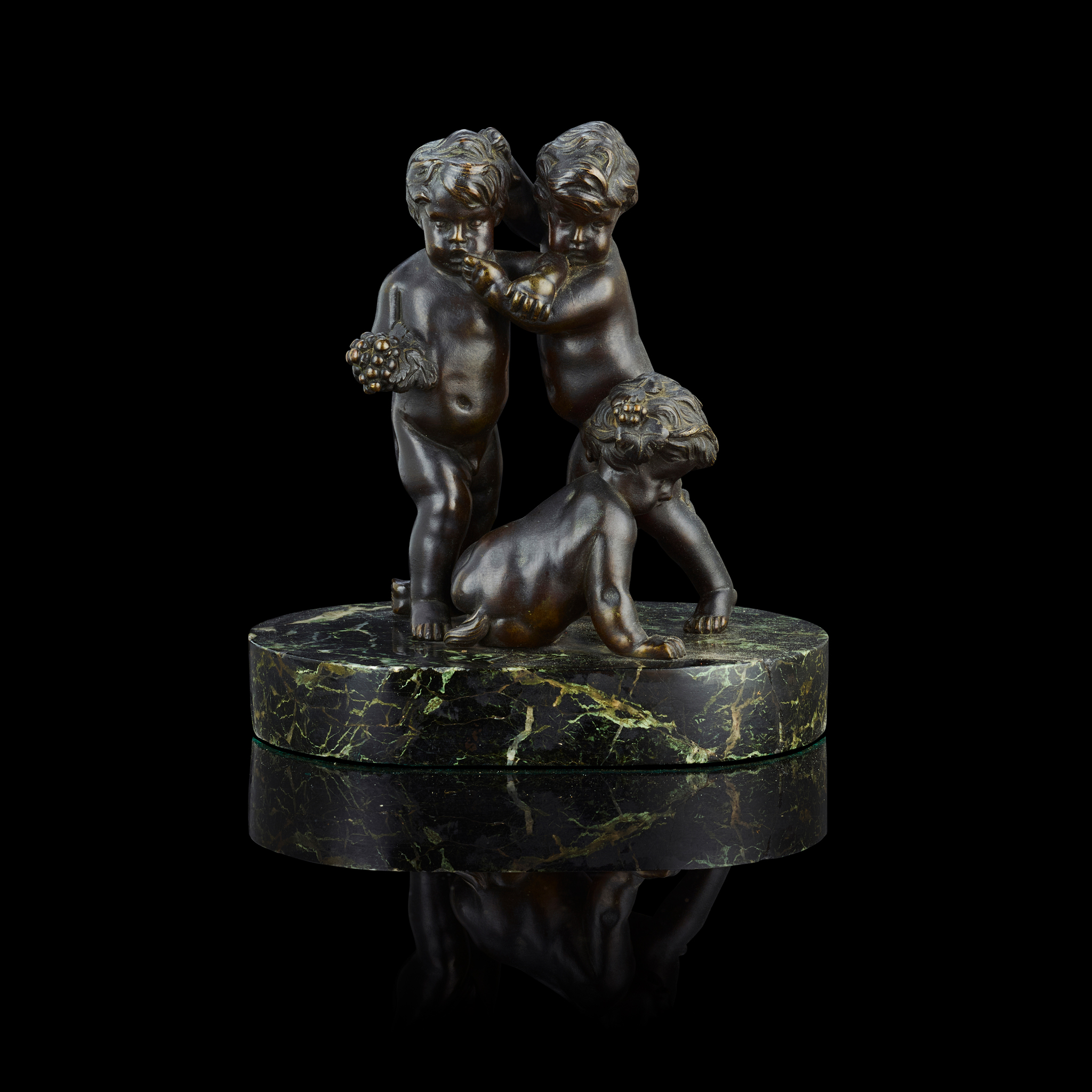 A FRENCH BRONZE FIGURE GROUP OF PUTTI AND SATYR AT PLAY, AFTER FRANÇOIS DUQUESNOY