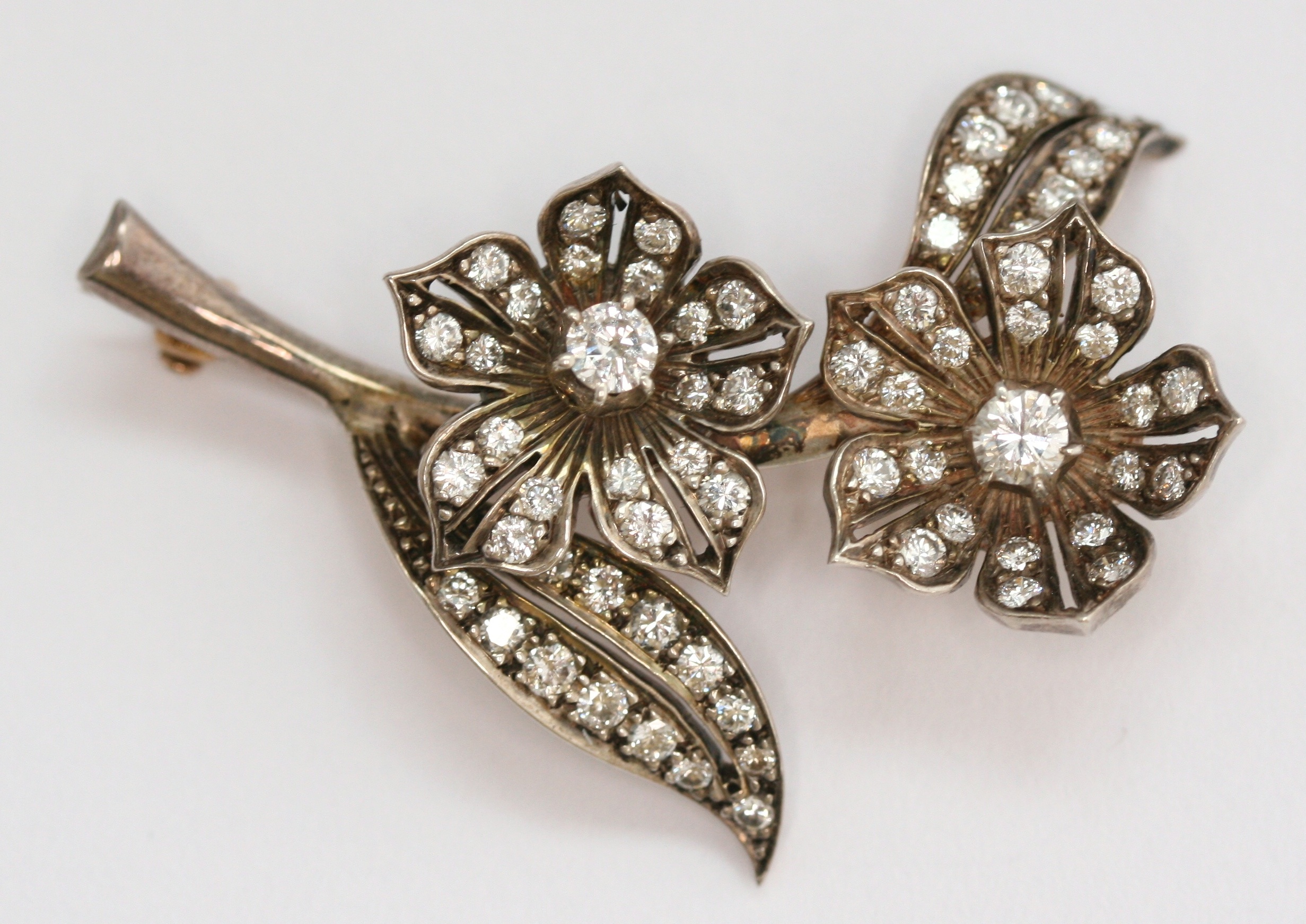 A diamond set floral spray brooch