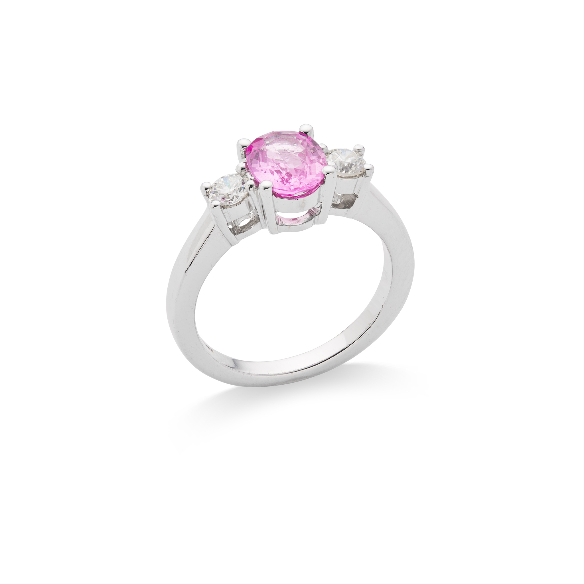A pink sapphire and diamond three-stone ring