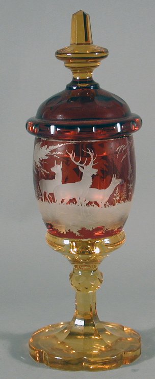 A late 19th century Bohemian ruby and amber glass goblet and cover