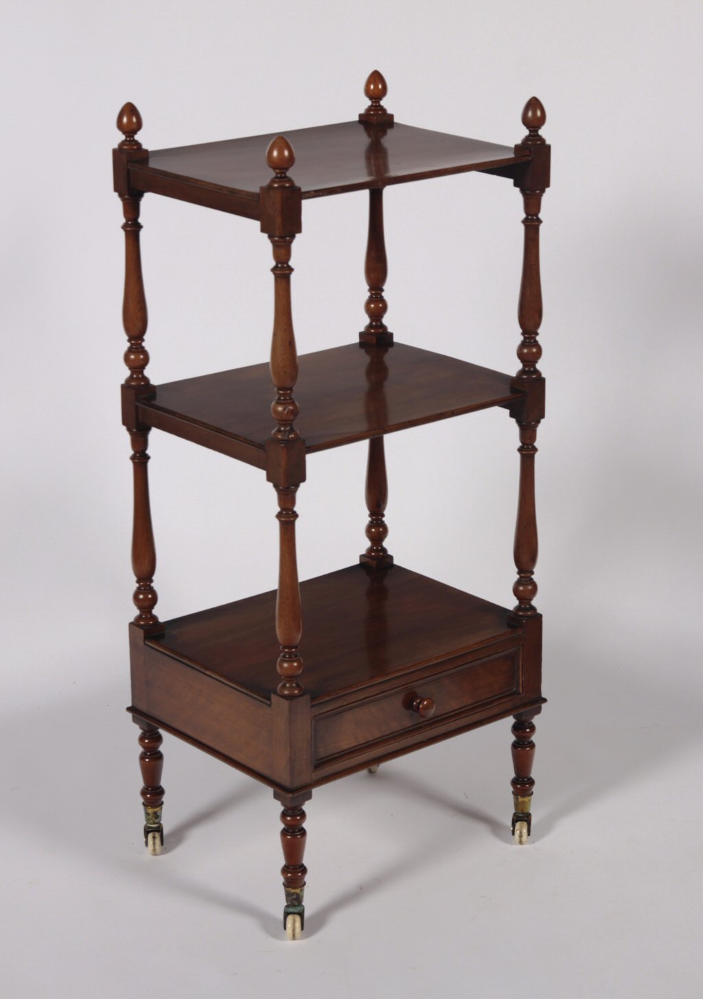 A late Victorian mahogany three tier whatnot