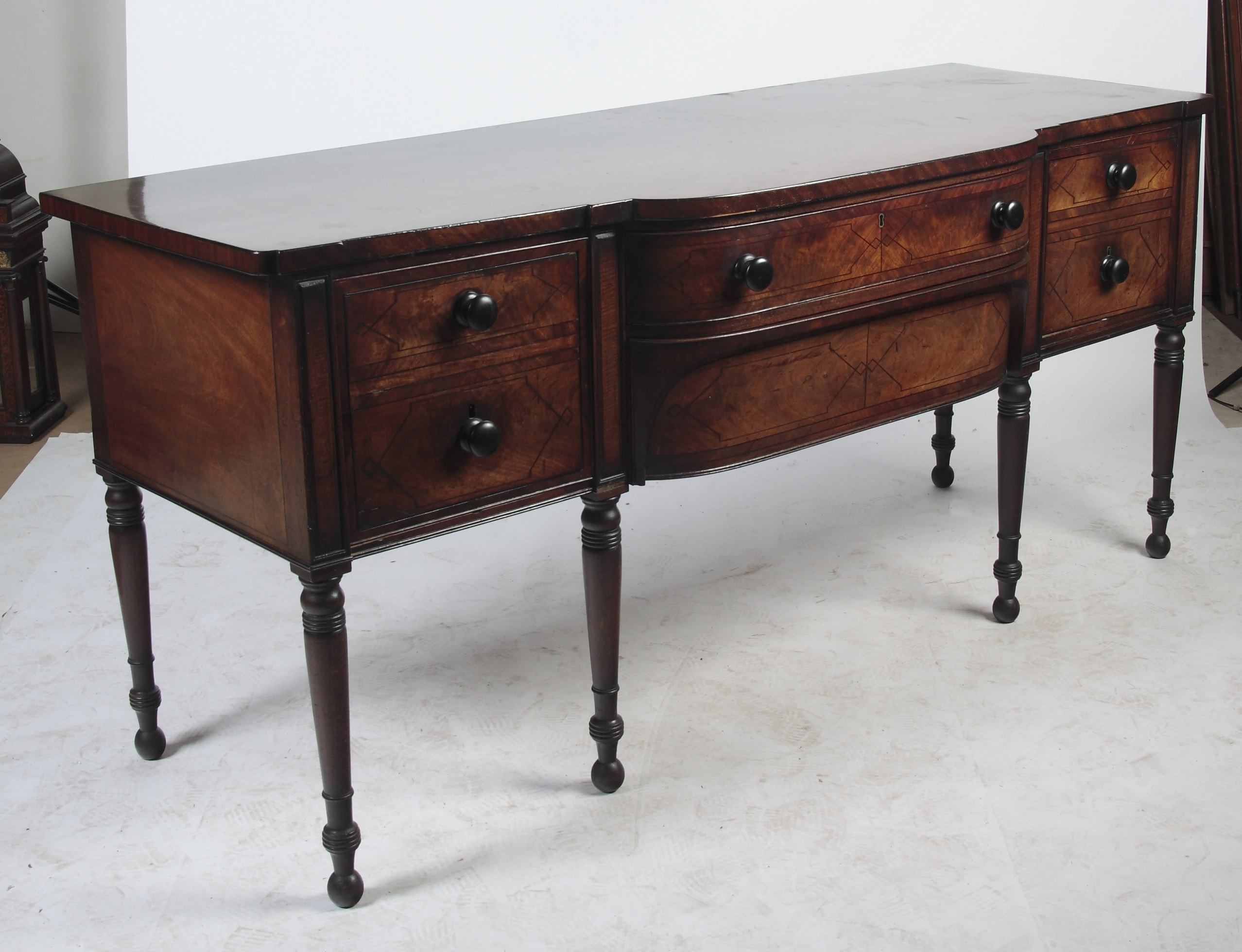 A Regency mahogany and ebony strung sideboard