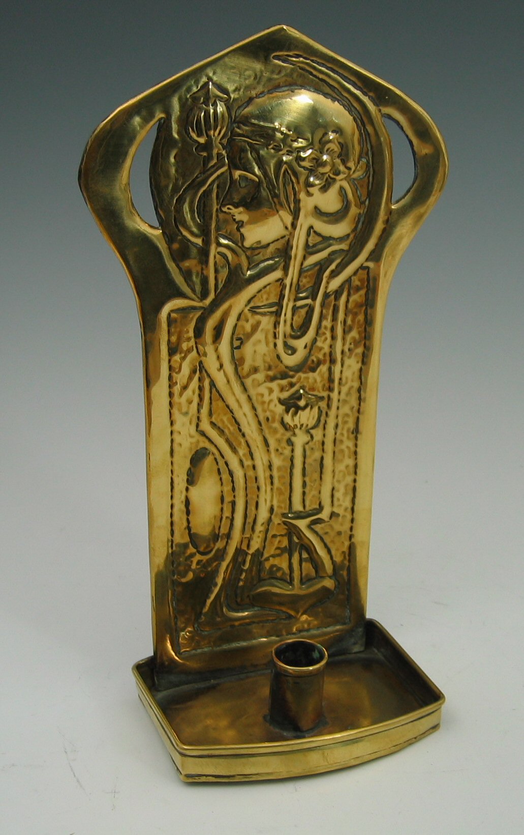 A Scottish Arts and Crafts brass candle sconce by Agnes Bankier Harvey,