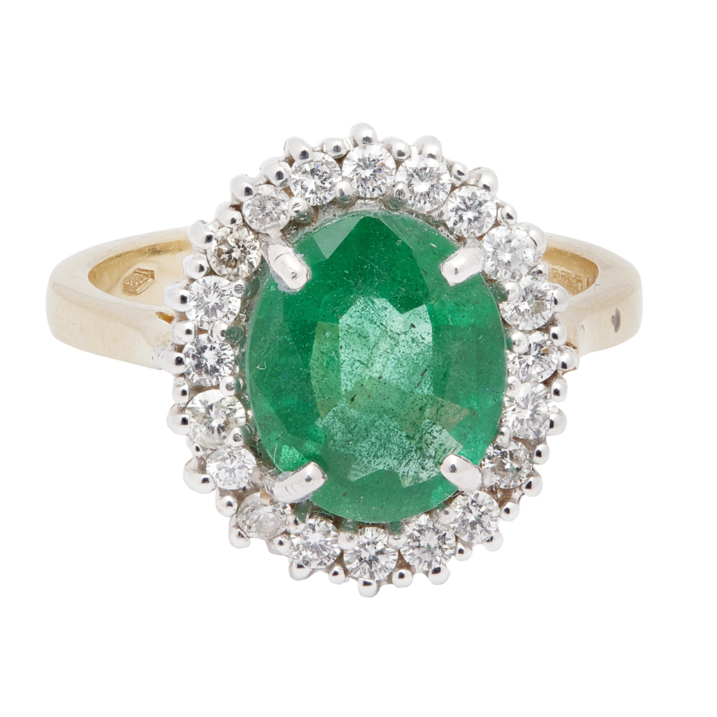 An emerald and diamond set cluster ring