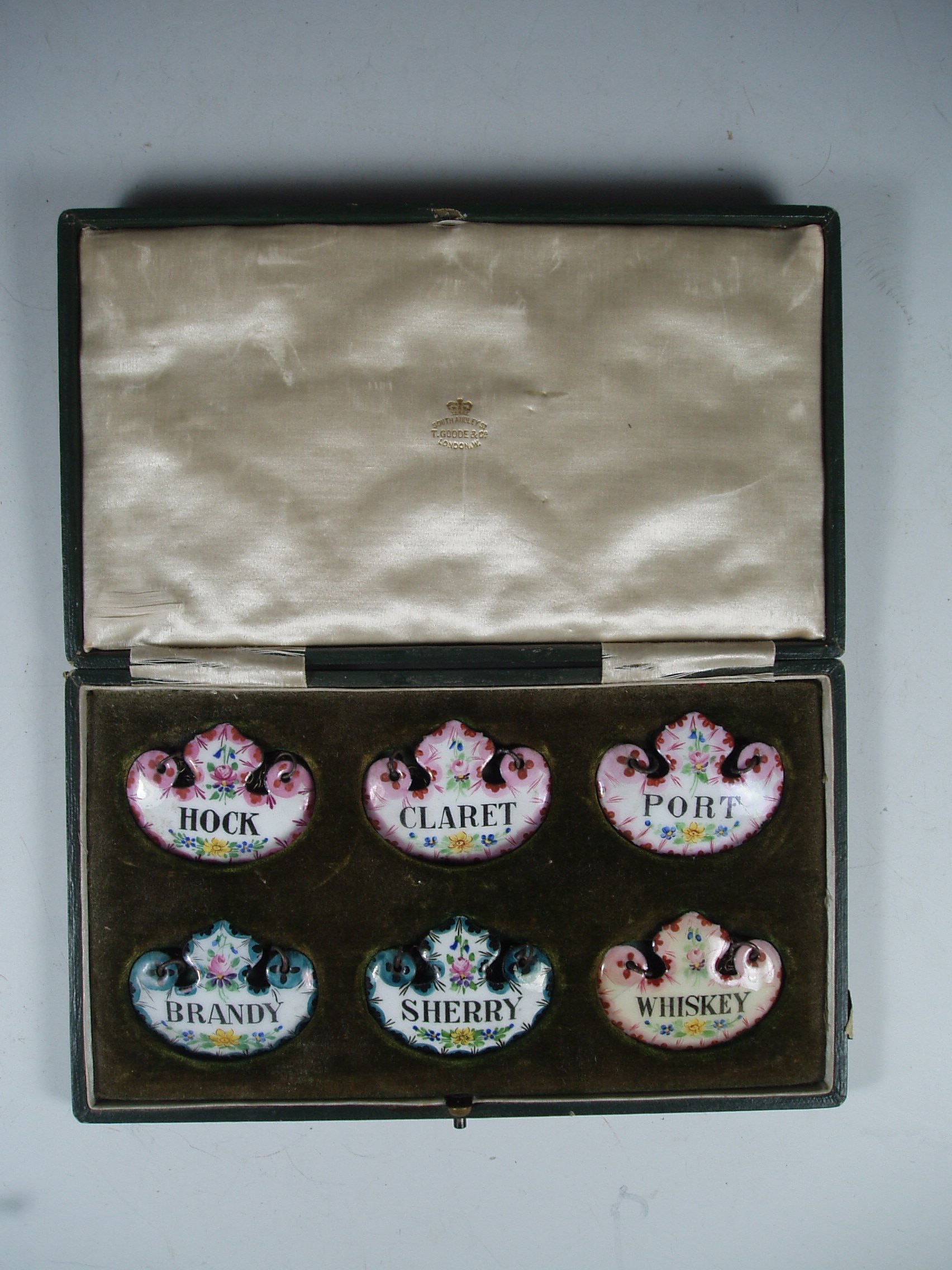 A set of six enamel spirit labels,