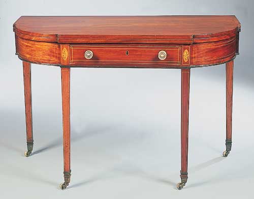 A George III mahogany and boxwood strung foldover tea table