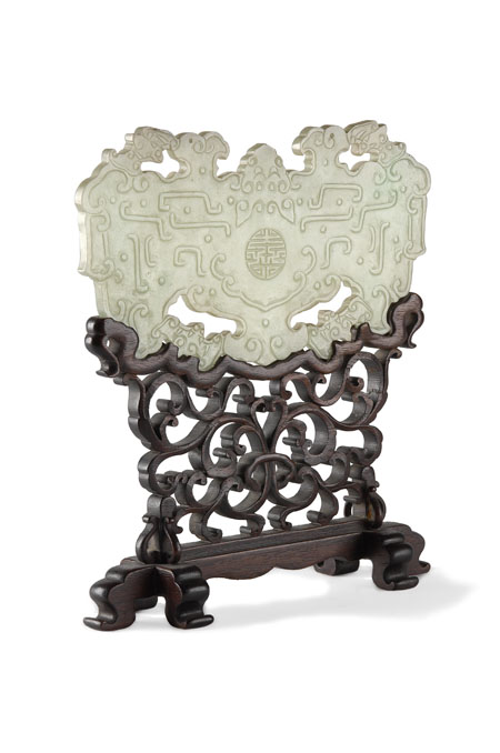 A Chinese pale green jade carved and pierced shaped contemplation screen