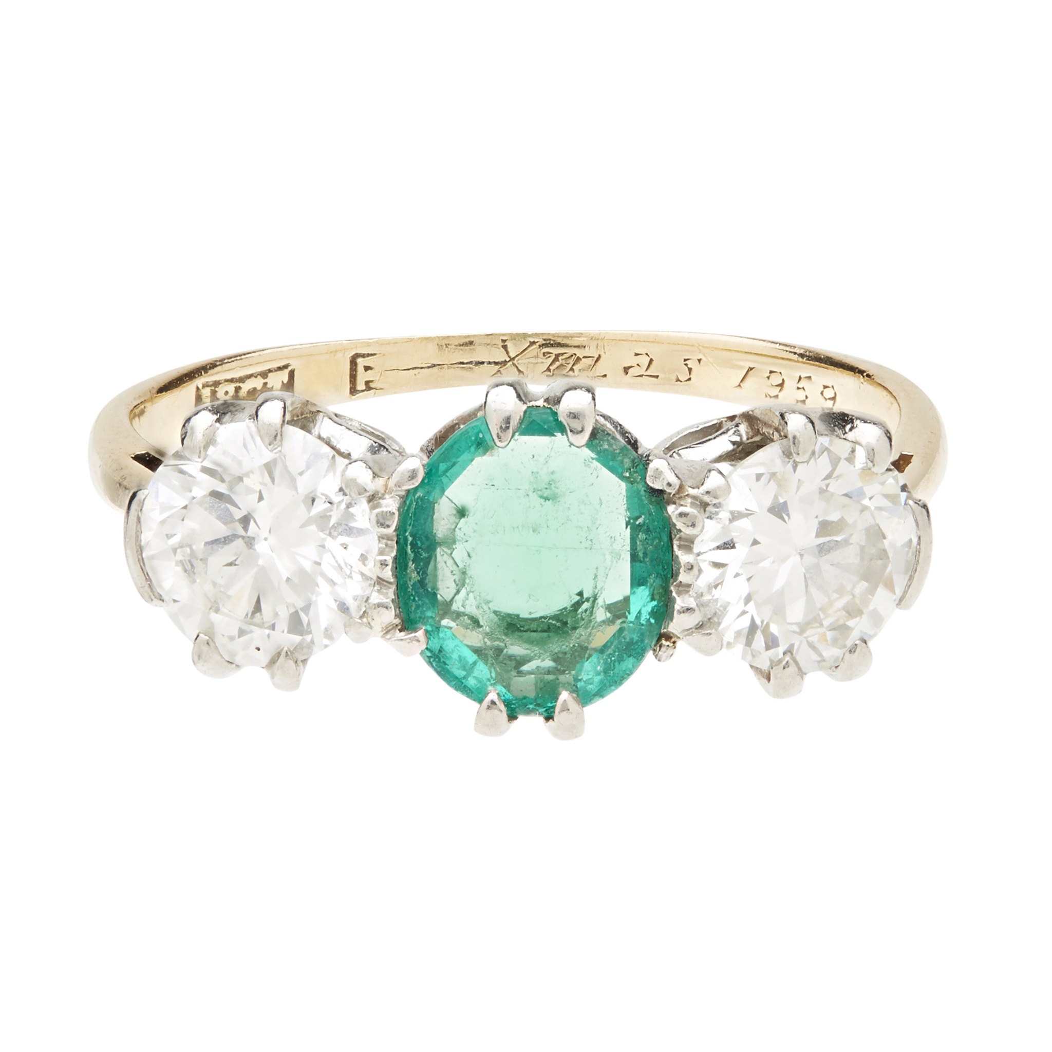An emerald and diamond set three stone ring