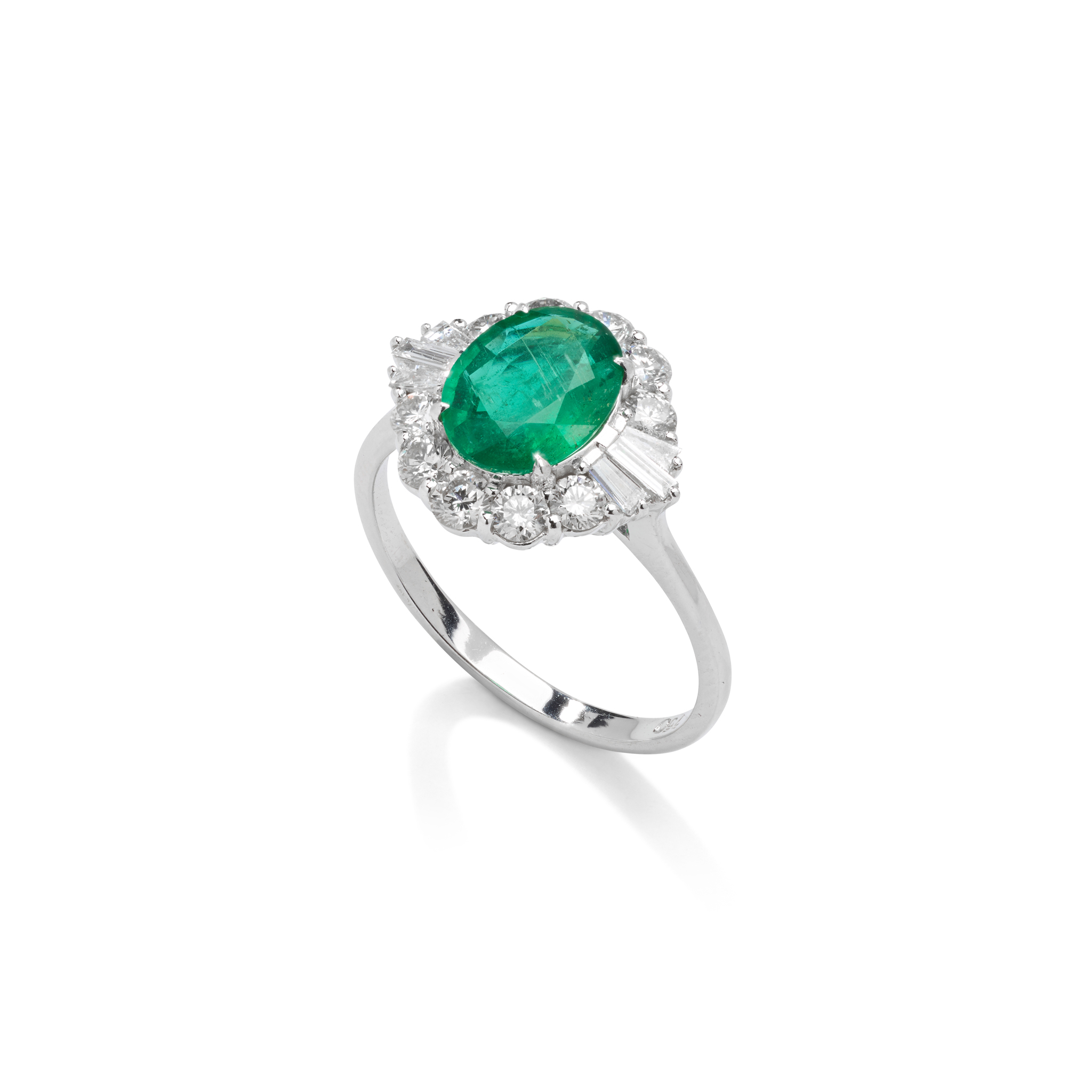 An emerald and diamond cluster ring