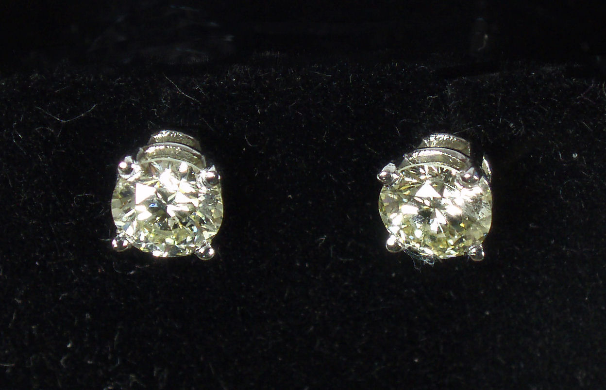 A pair of 18ct gold mounted diamond set earrings,