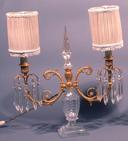 A pair of neoclassical style cut glass and gilt metal two branch candelabra