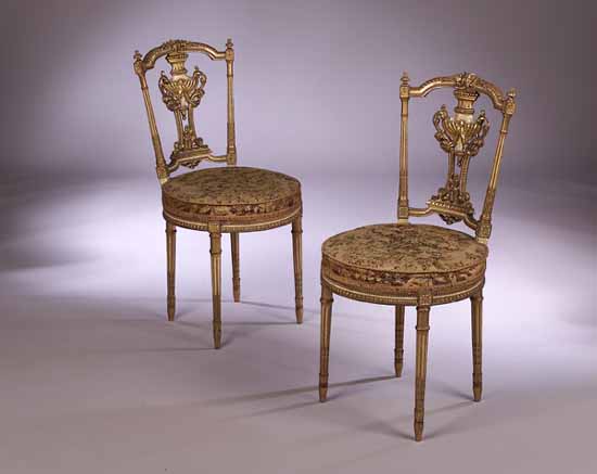 A pair of French Empire boudoir chairs