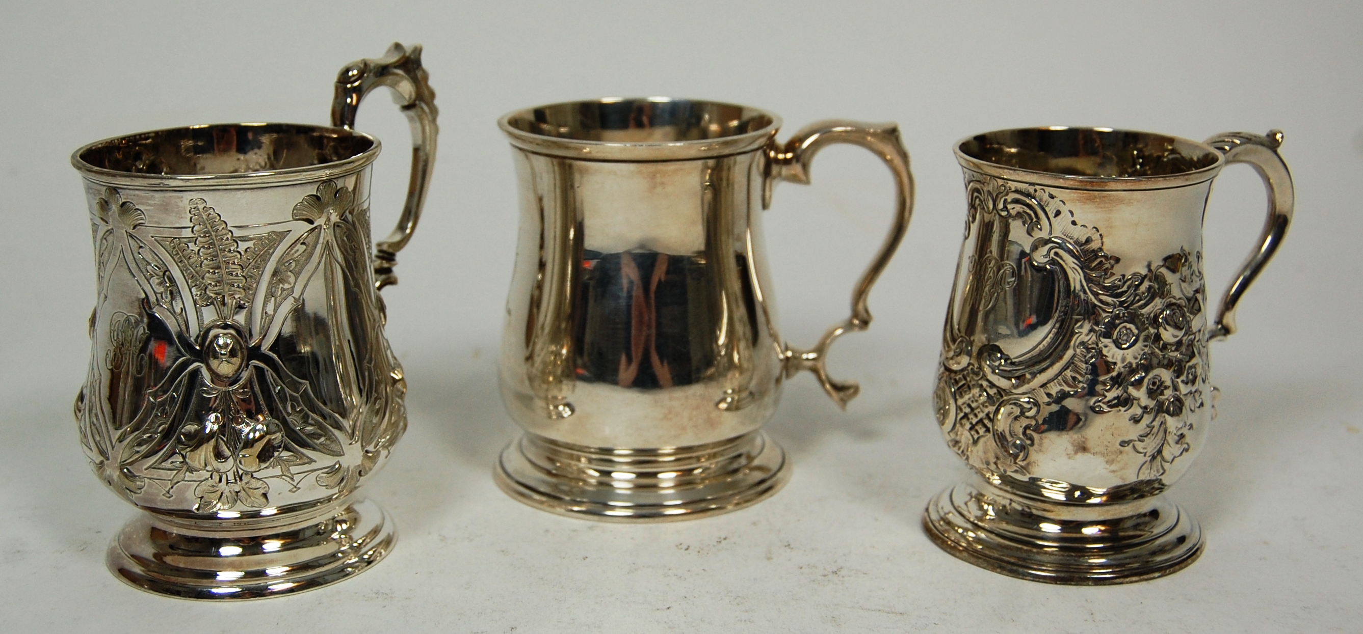 A group of three christening mugs