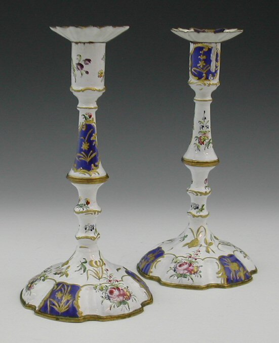 A pair of 18th century Battersea enamel candlesticks,