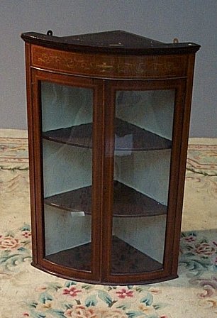 An Edwardian mahogany hanging corner cabinet