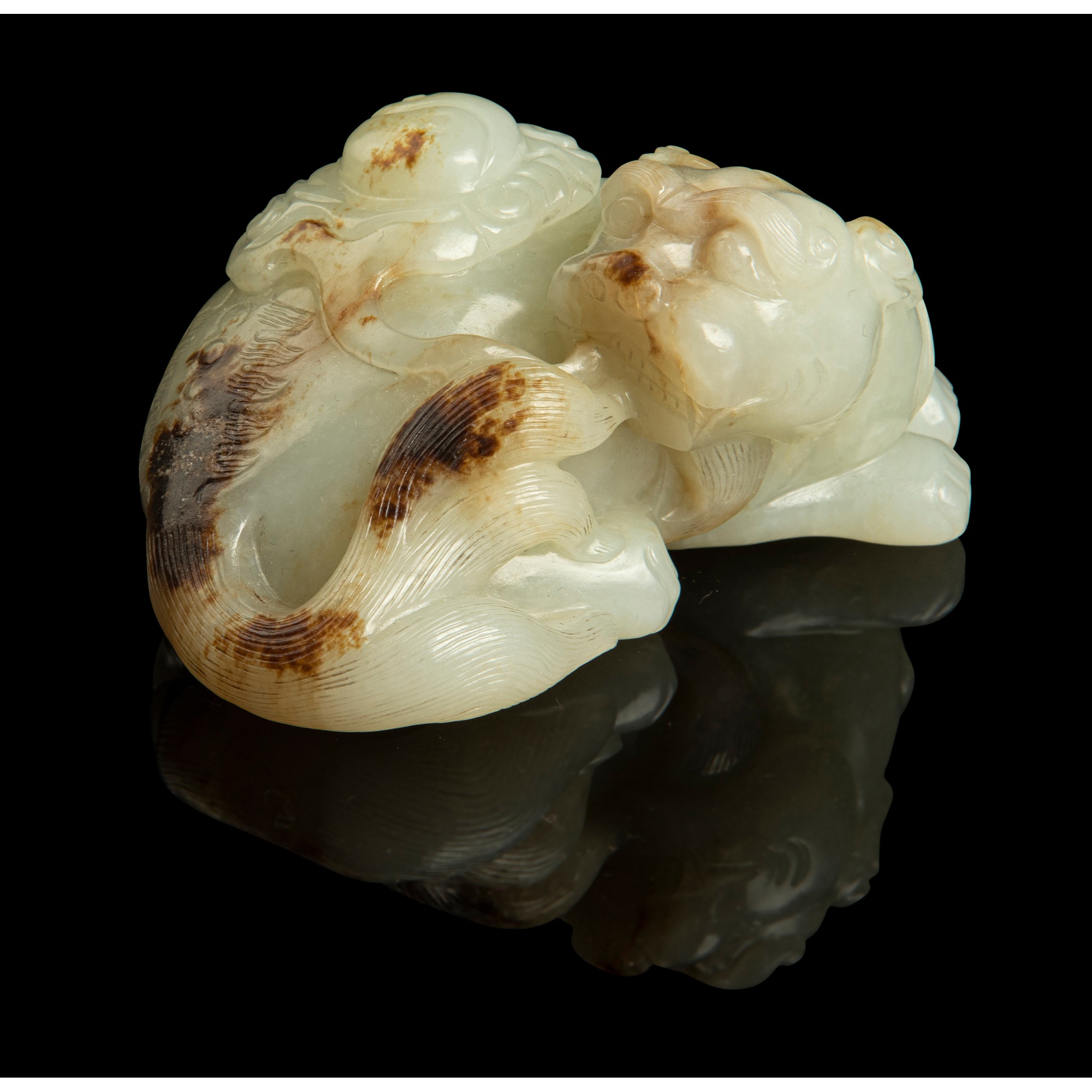 PALE CELADON WITH RUSSET SKIN JADE CARVING OF A MYTHICAL CREATURE WITH 'BAGUA'