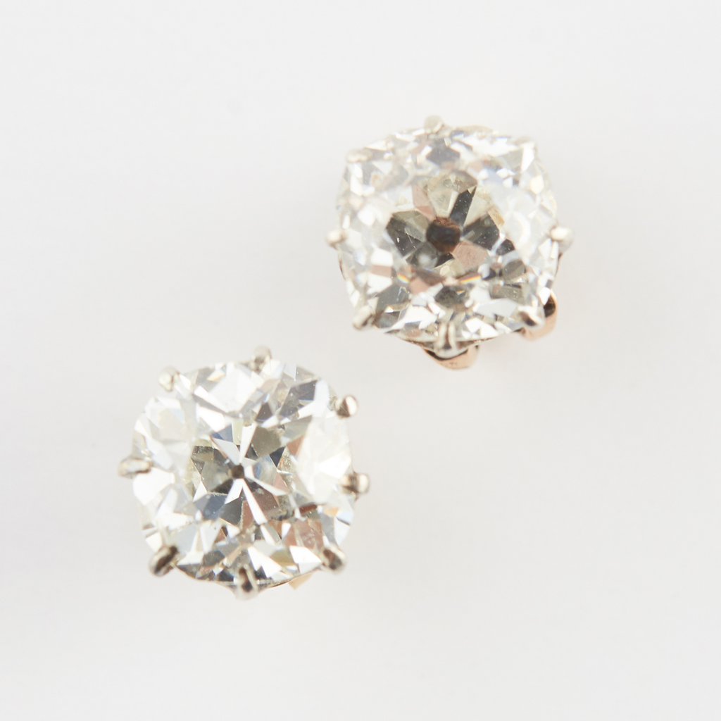 A pair of old cushion cut diamond stud earrings