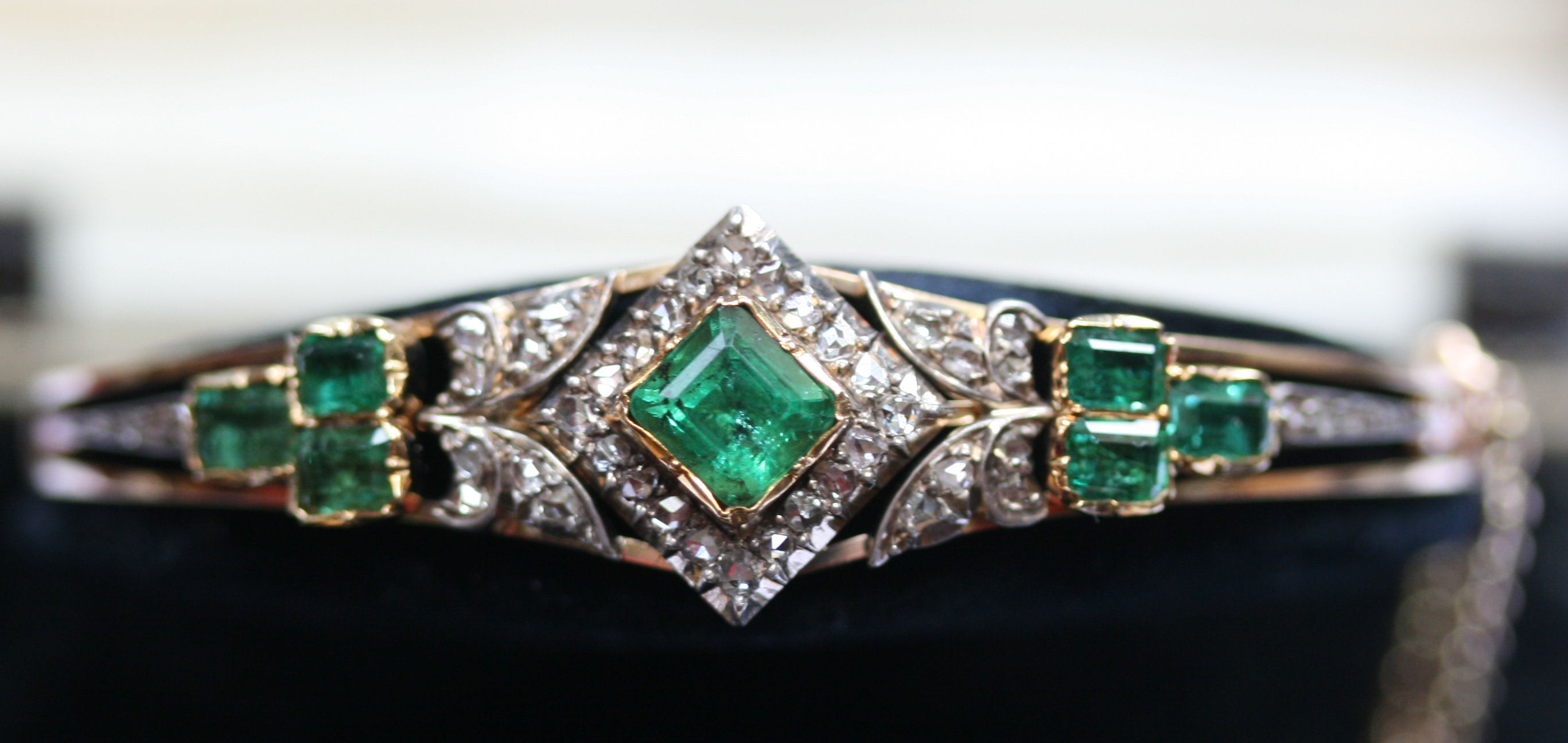 An Edwardian emerald and diamond set bangle
