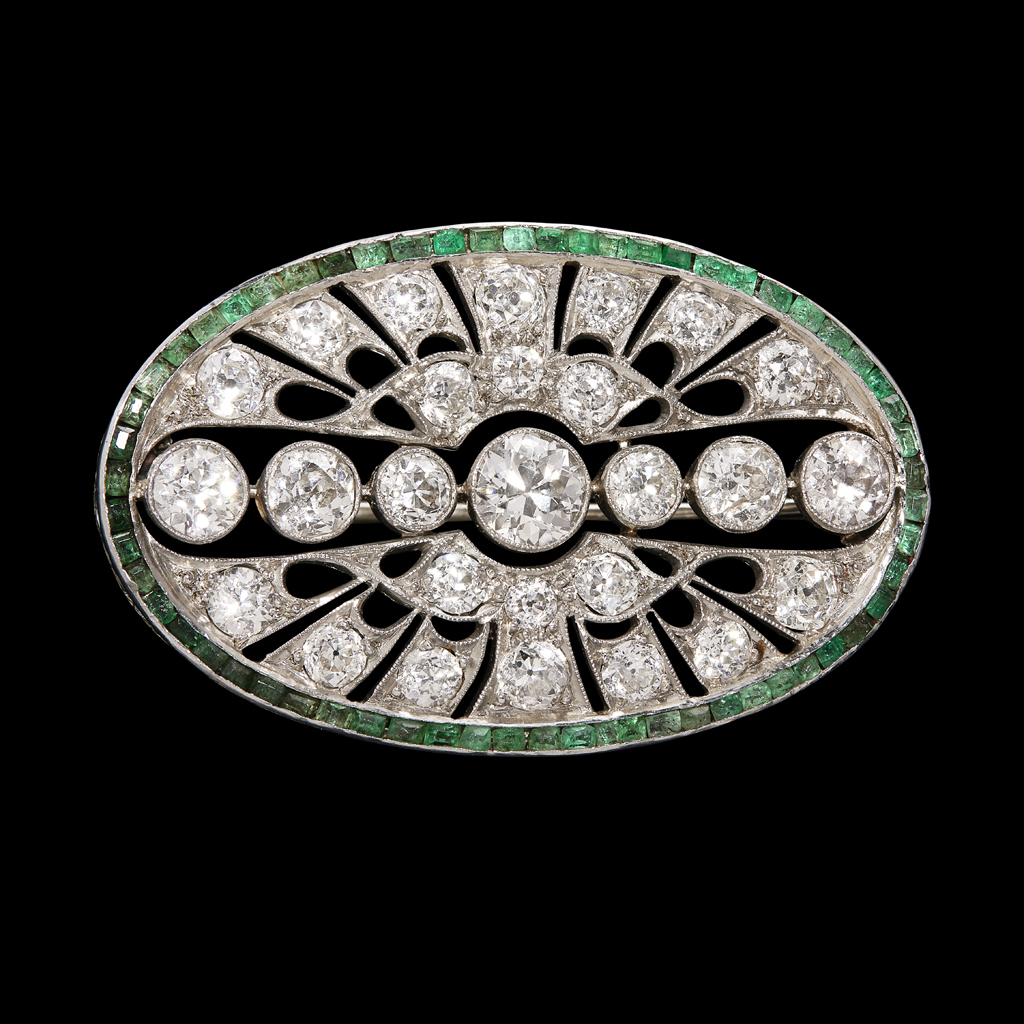 An early 20th century diamond and emerald set brooch