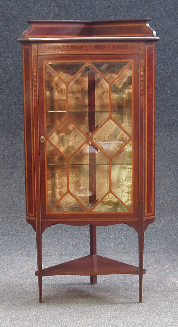 Change Est 300-500 An Edwardian inlaid mahogany corner cabinet,