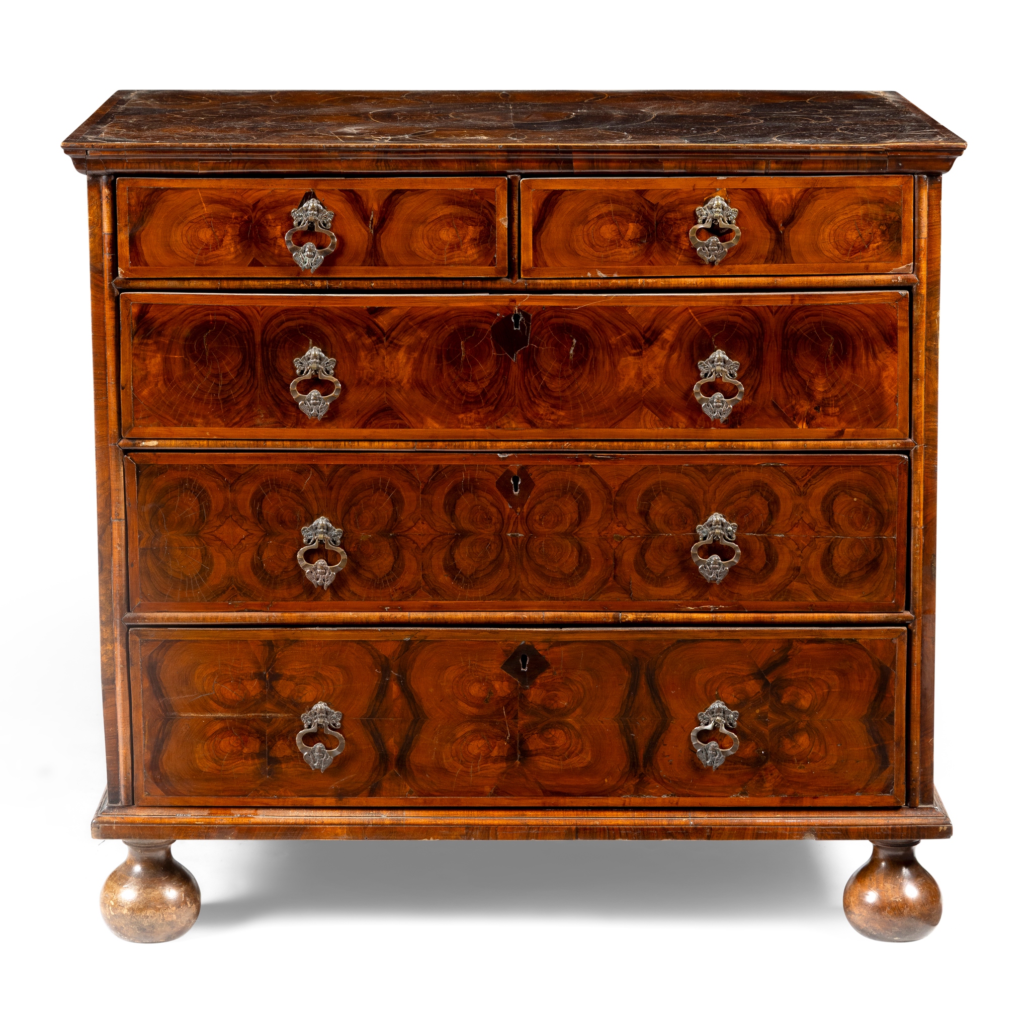 A WALNUT OYSTER VENEER CHEST OF DRAWERS