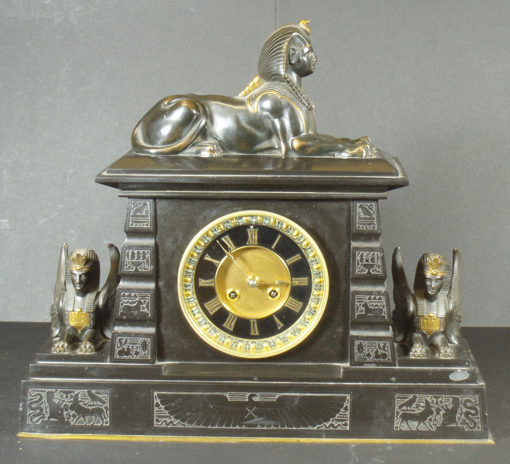 A Victorian Egyptian Revival slate and gilt metal mantel clock