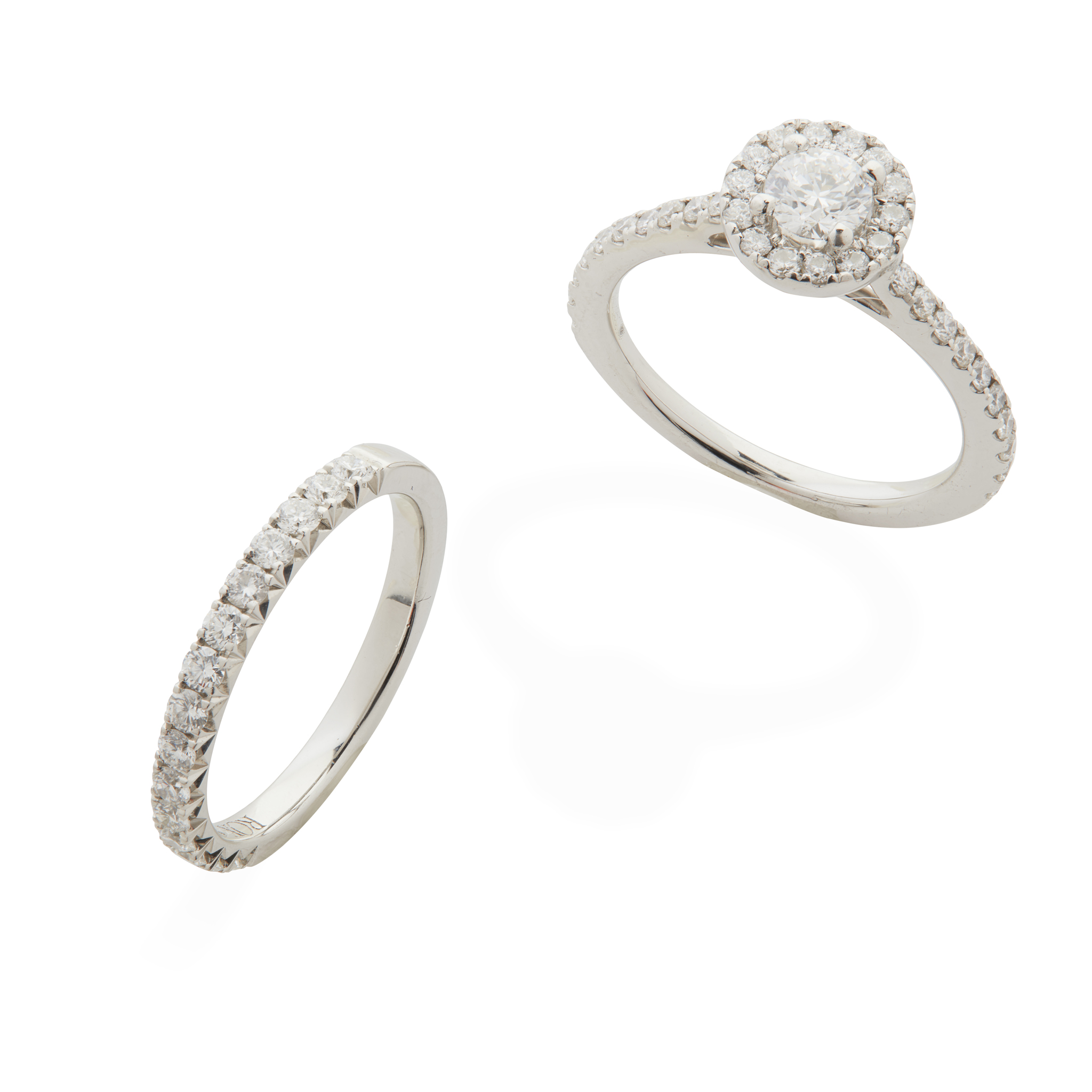 A platinum diamond cluster ring and matching half-eternity band