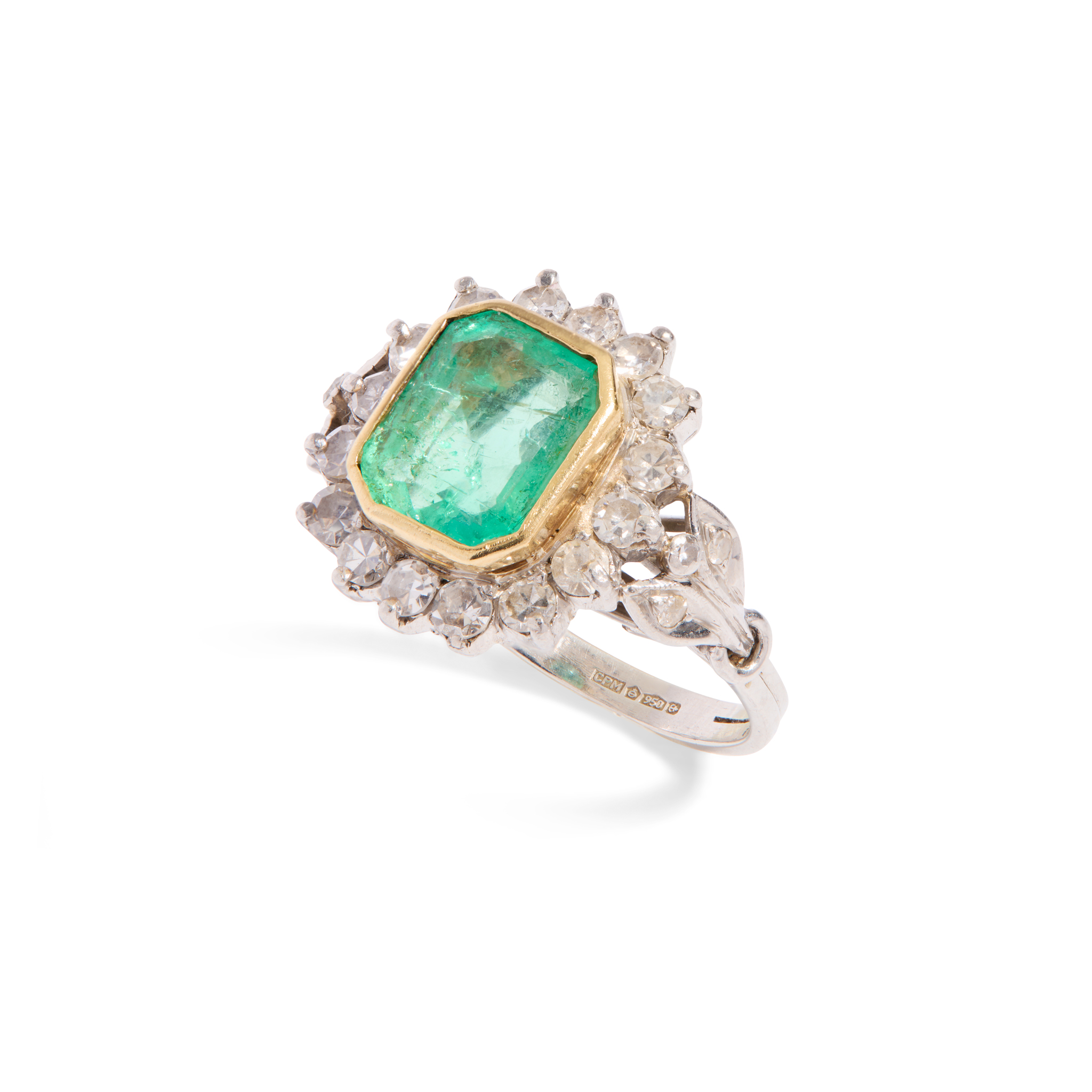 A platinum emerald and diamond cluster ring