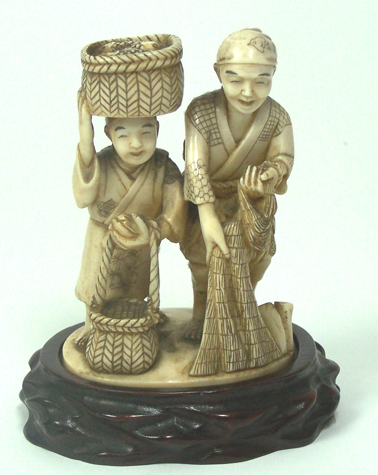 A Japanese ivory okimono of two fisherman, Meiji period Signed Saul Mitsu