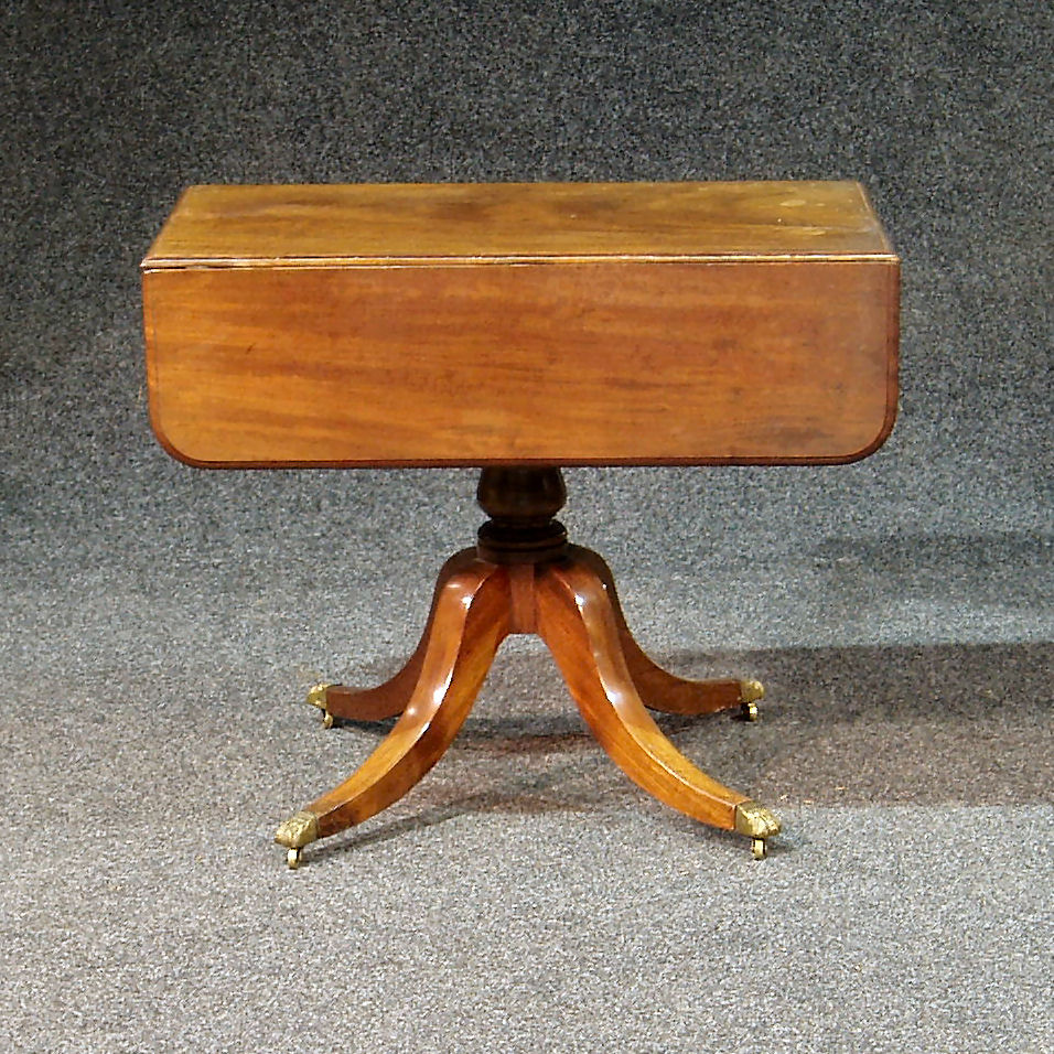An early 19th century mahogany drop leaf supper table,
