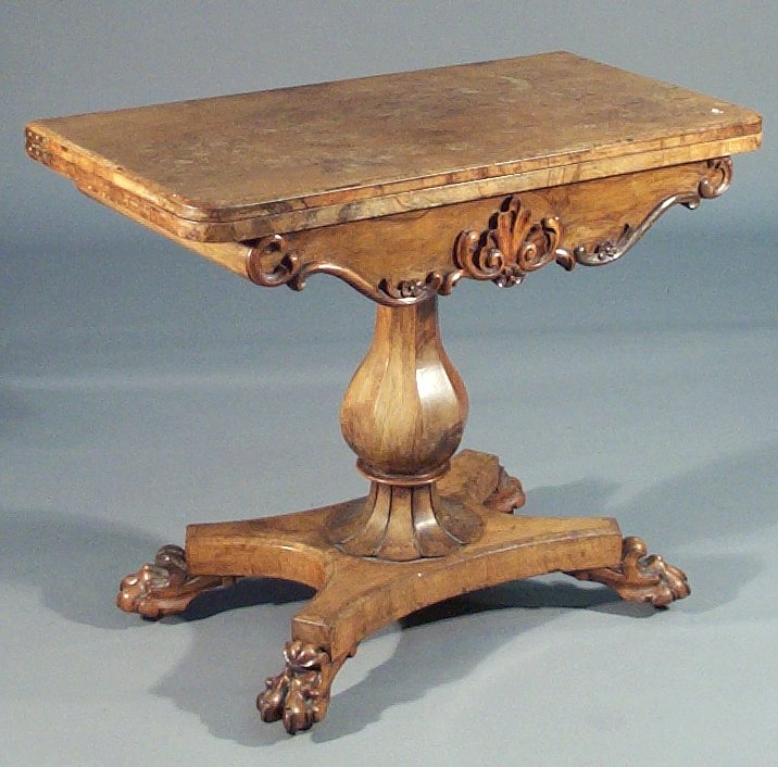 An early Victorian walnut turnover tea table