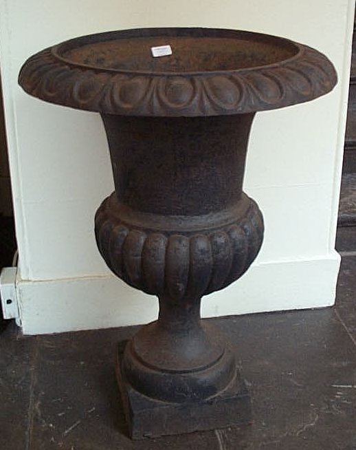 A pair of cast iron garden urns,