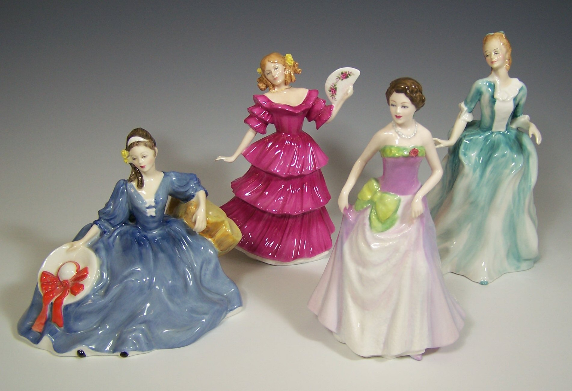 A collection of Royal Doulton figurines,