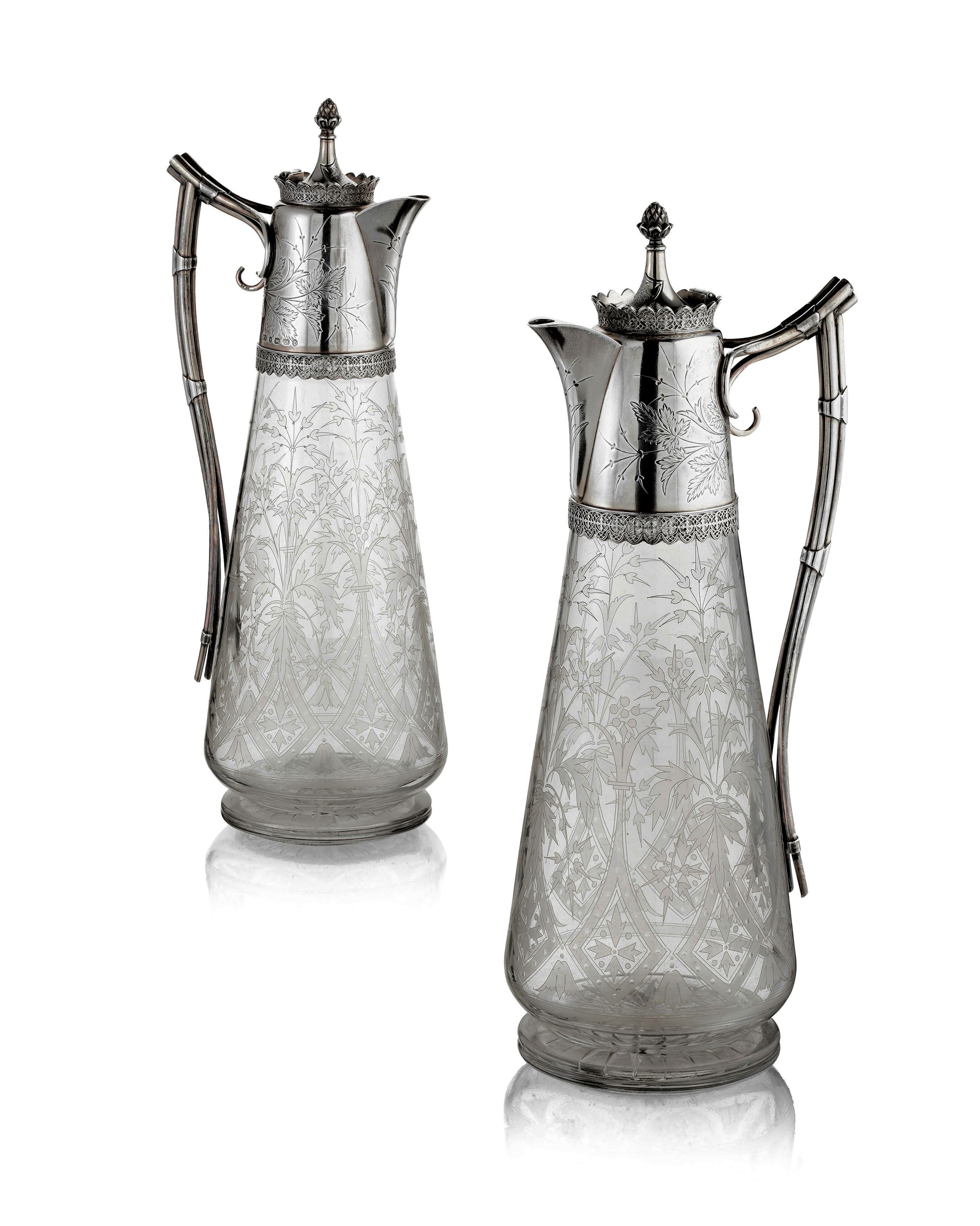 A good pair of Victorian silver mounted claret jugs