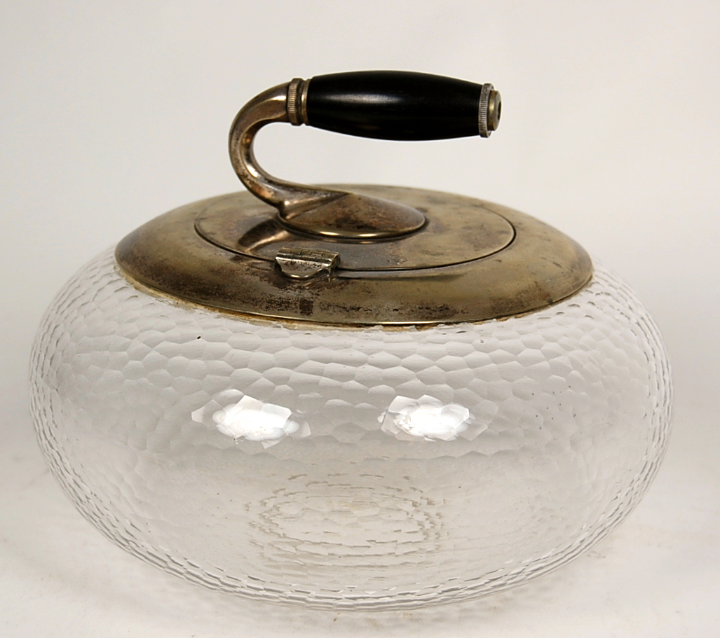 A novelty silverplated 'curling stone' biscuit box