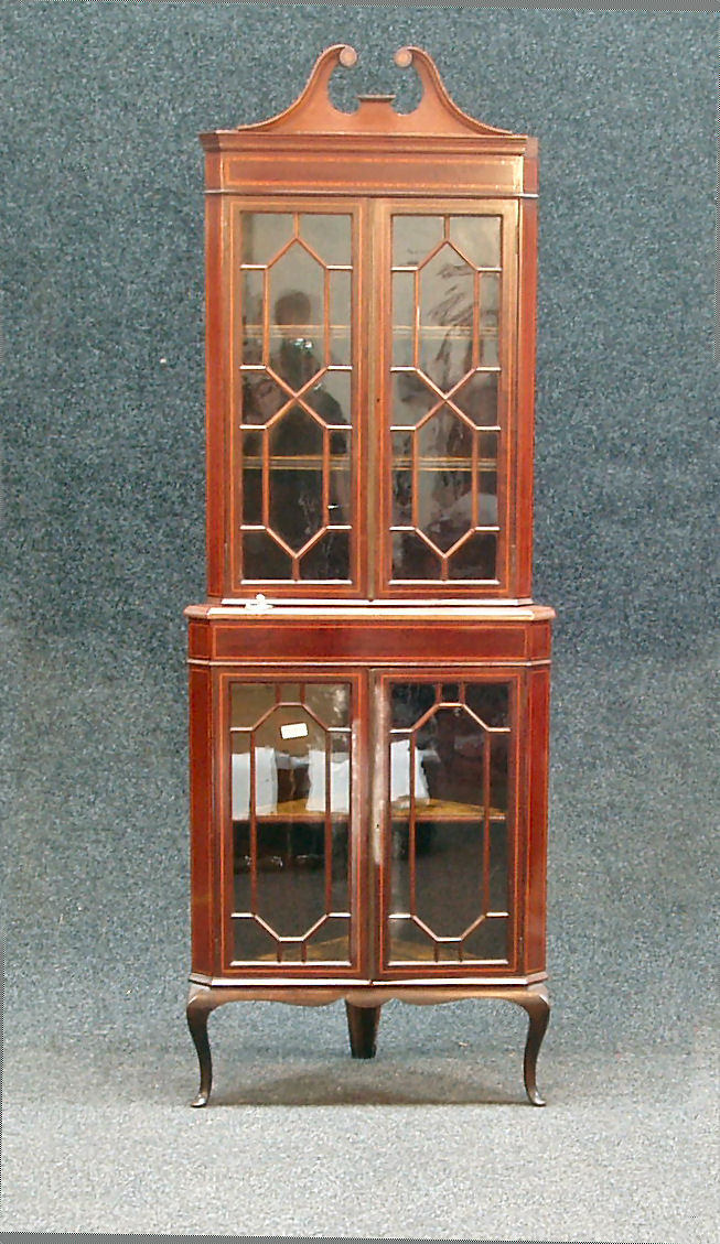 An Edwardian mahogany, ebony and satinwood banded corner cabinet,